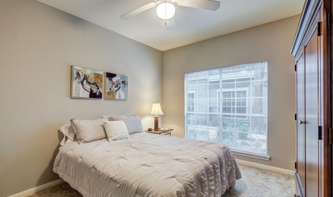 a bedroom with a large window