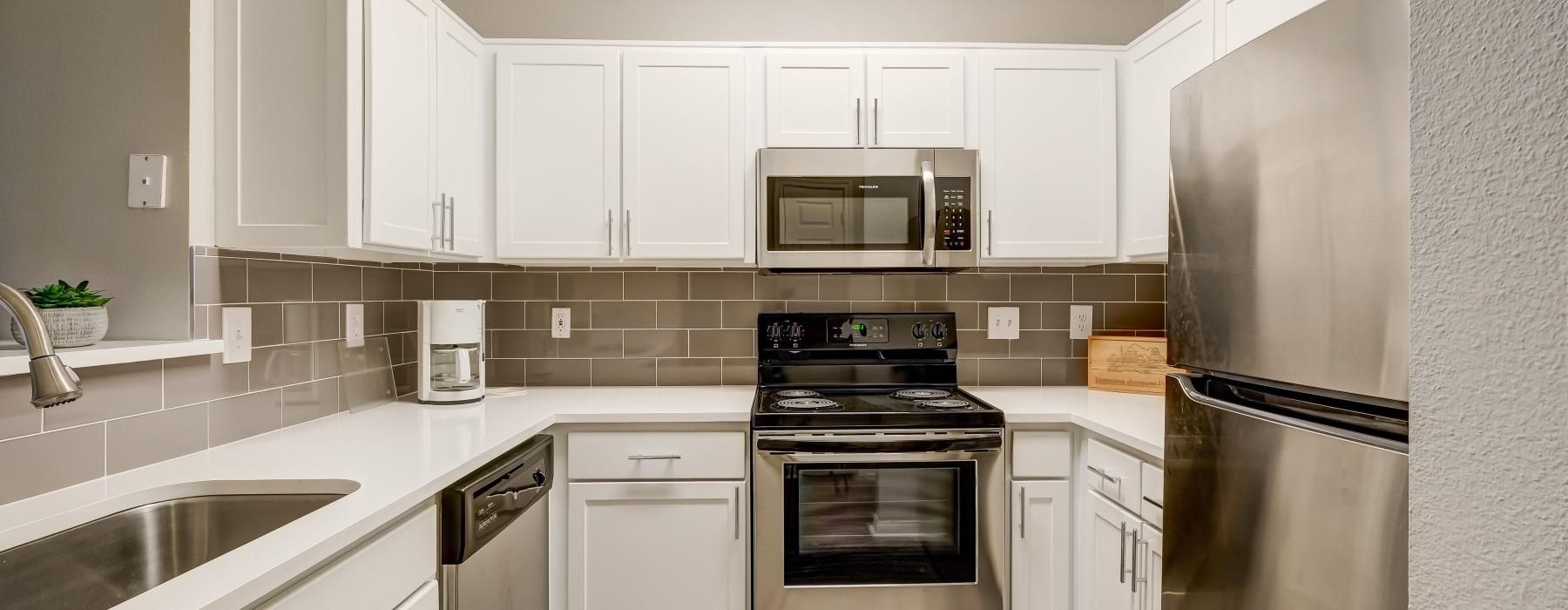 a kitchen with white cabinets