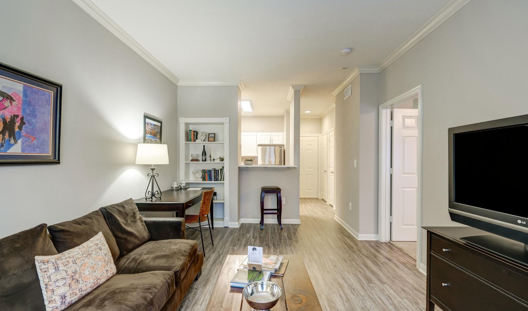 a living room with a tv and couches