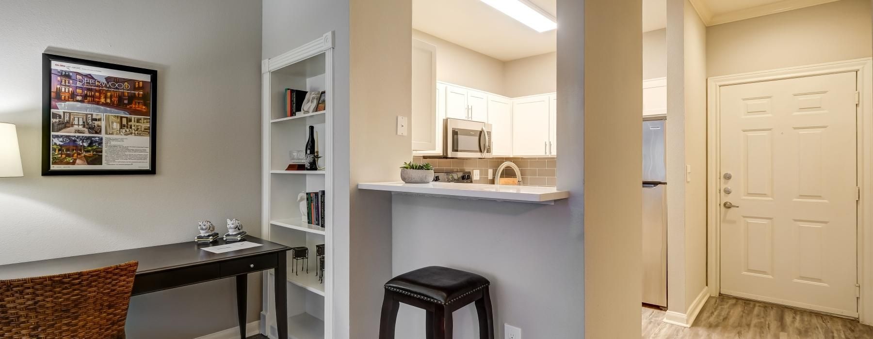 a kitchen with a bar stool