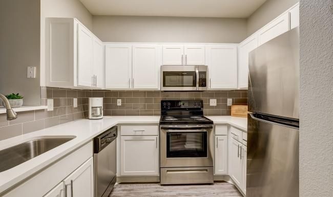 a kitchen with white cabinets